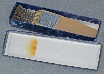 Staticmaster 1 inch brush with radiation burn to the lid, in Company Seven's collection (98,265 bytes)